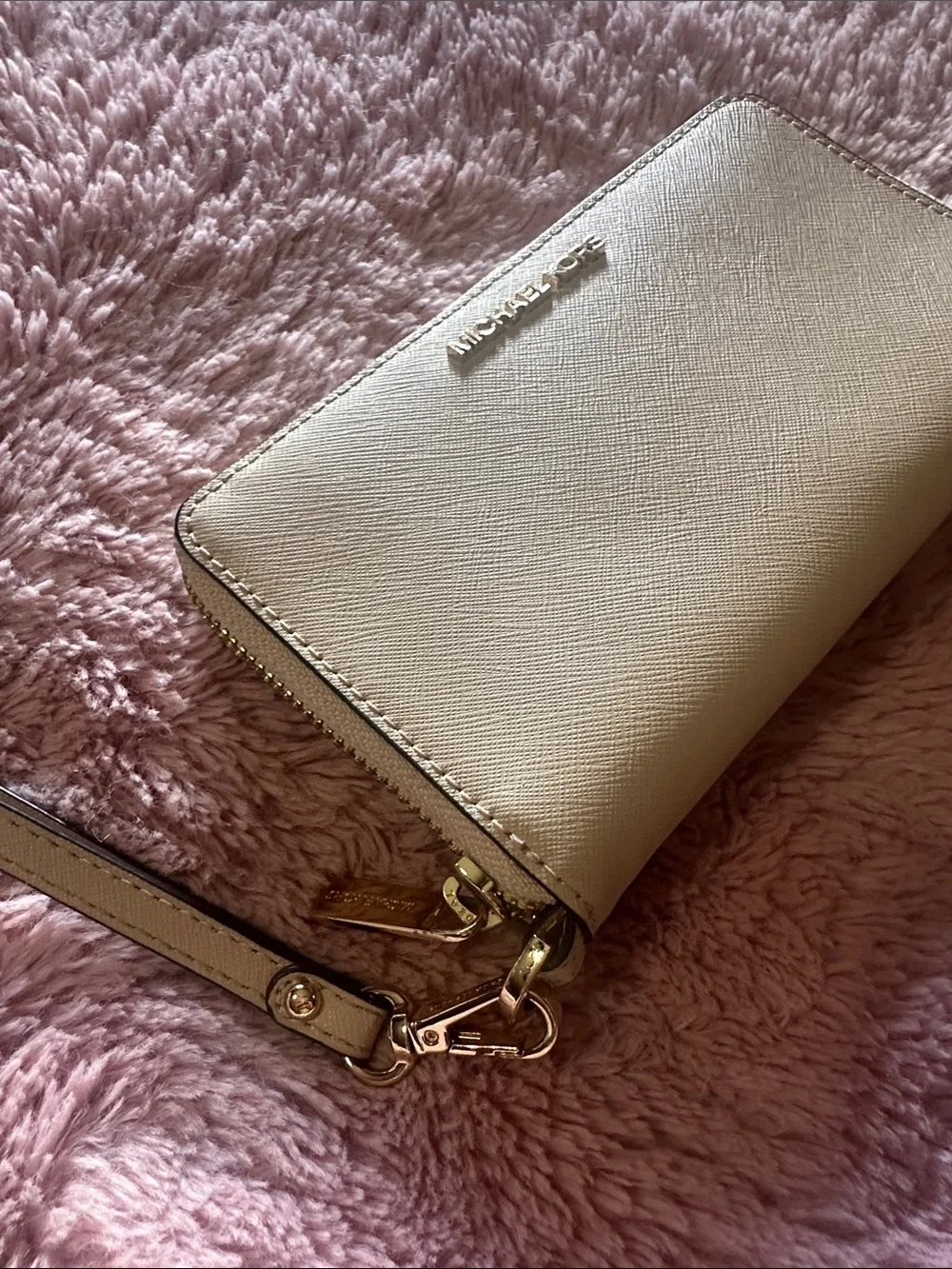 MK wristlet in light tan/ Beige
